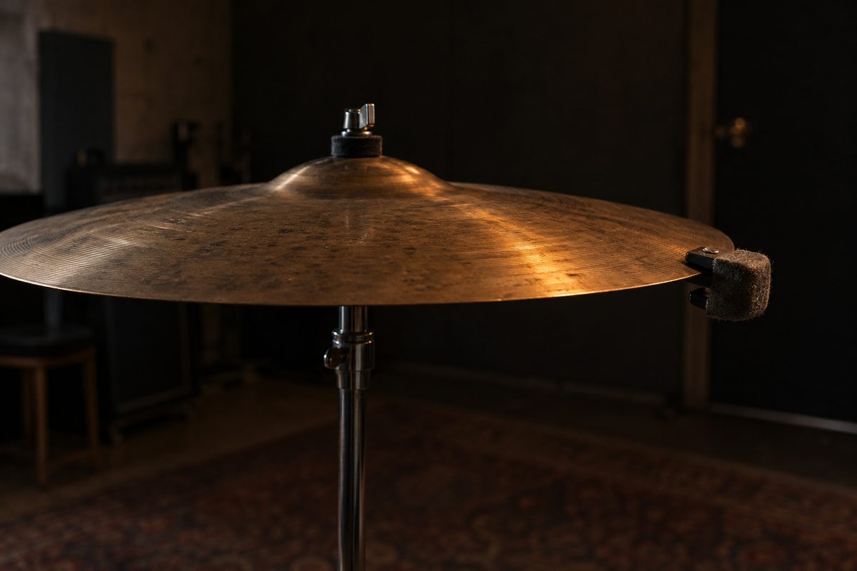A felt mute clipped to the edge of a suspended bronze cymbal